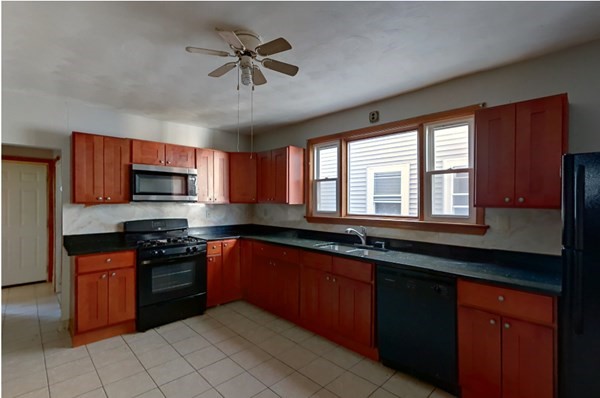 a kitchen with stainless steel appliances granite countertop stove top oven a sink dishwasher and a microwave oven