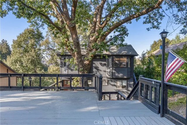 a view of a balcony with wooden floor and outdoor seating