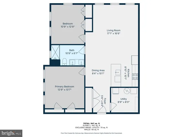 a car parked in front of a brick house with a small yard