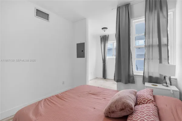 a bedroom with a bed and a mirror