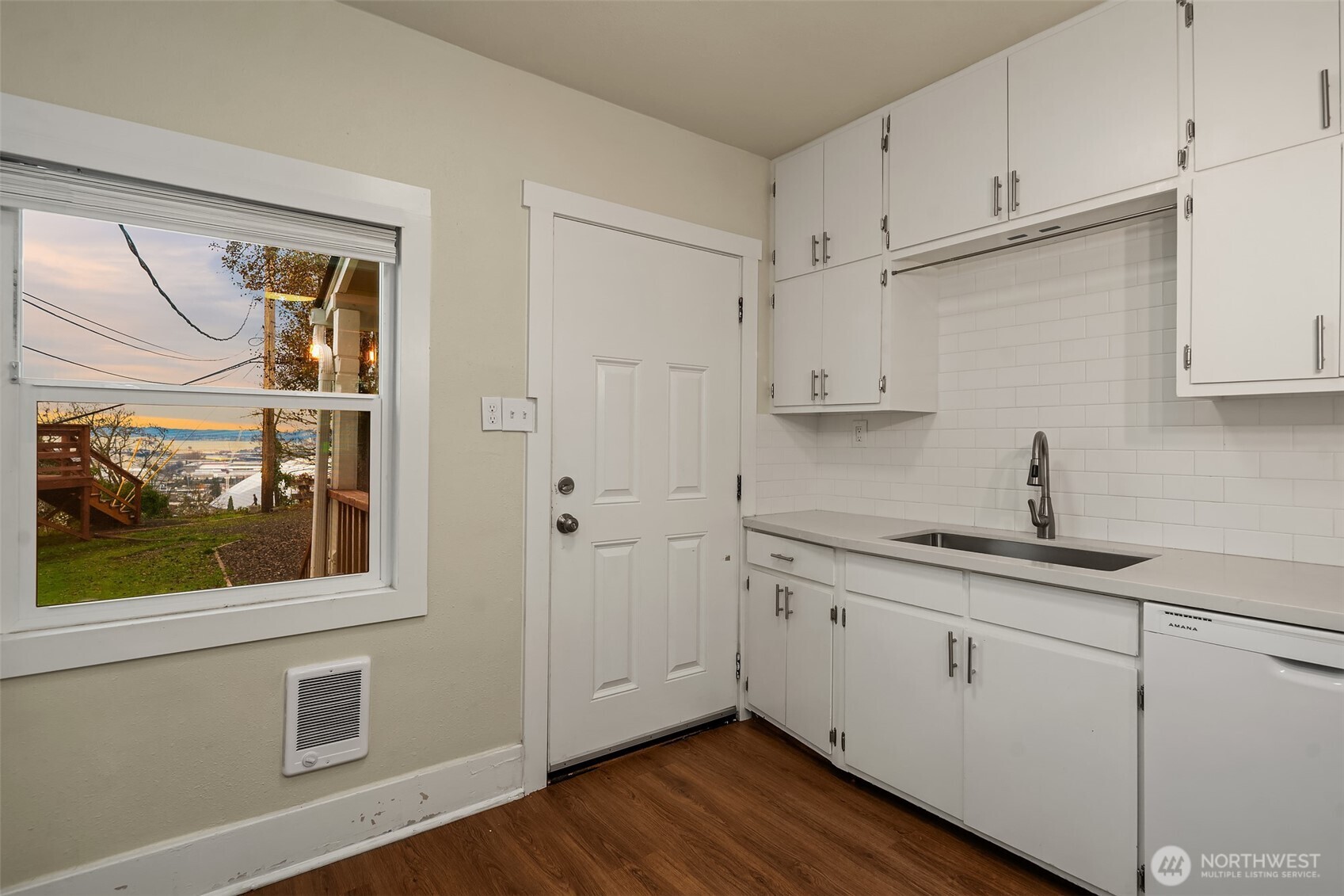 403 East Wright Avenue Tacoma, WA 98404 - Photo 16 of 29 a kitchen with white cabinets and wooden floor