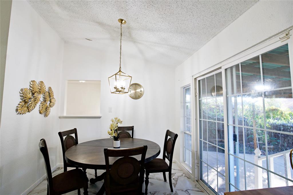 2025 High Bluff Drive Garland, TX 75041 - Photo 13 of 35 a view of a dining room with furniture wooden floor and chandelier