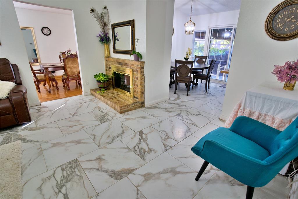 2025 High Bluff Drive Garland, TX 75041 - Photo 15 of 35 a view of a livingroom with furniture and a dining table with rug