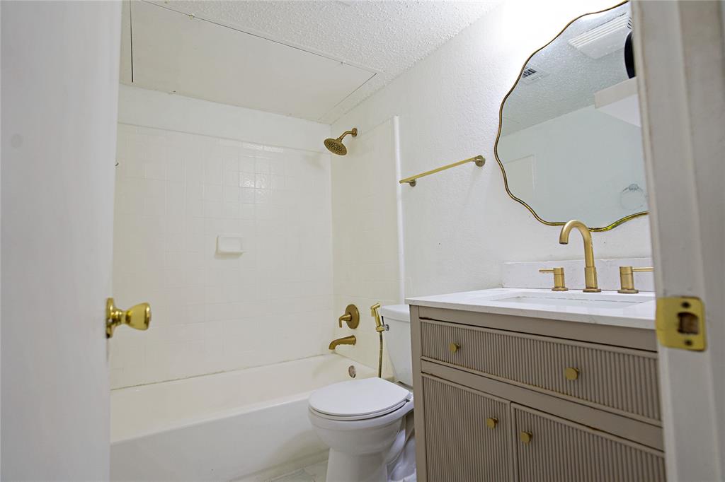 2025 High Bluff Drive Garland, TX 75041 - Photo 16 of 35 a bathroom with a sink mirror vanity and toilet