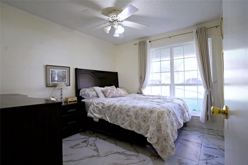 2025 High Bluff Drive Garland, TX 75041 - Photo 18 of 35 a bedroom with a bed and a window