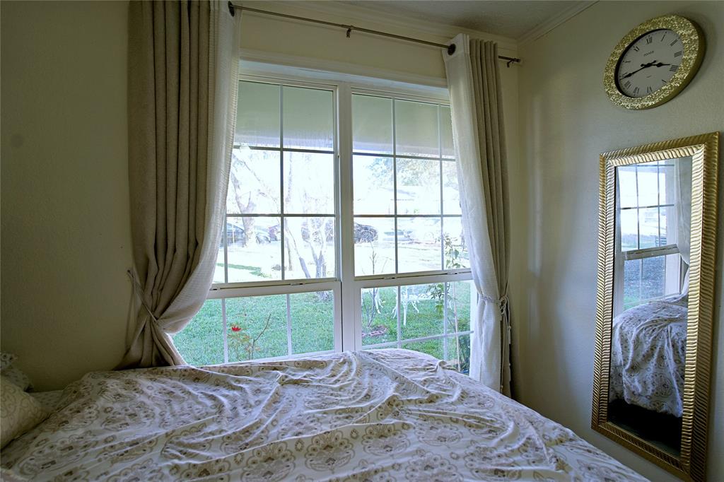 2025 High Bluff Drive Garland, TX 75041 - Photo 19 of 35 a bedroom with a bed and a window