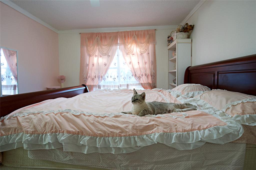 2025 High Bluff Drive Garland, TX 75041 - Photo 20 of 35 a bedroom with a bed and window