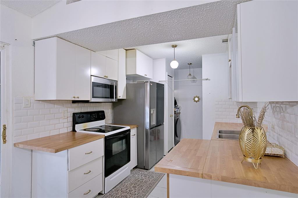 2025 High Bluff Drive Garland, TX 75041 - Photo 10 of 35 a kitchen with stainless steel appliances granite countertop a refrigerator sink and stove