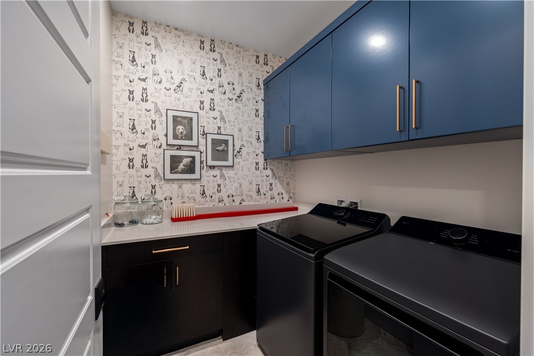 9719 Starlight Ridge Avenue Las Vegas, NV 89148 - Photo 15 of 25 A well-appointed laundry room features ample counter space and stylish storage.