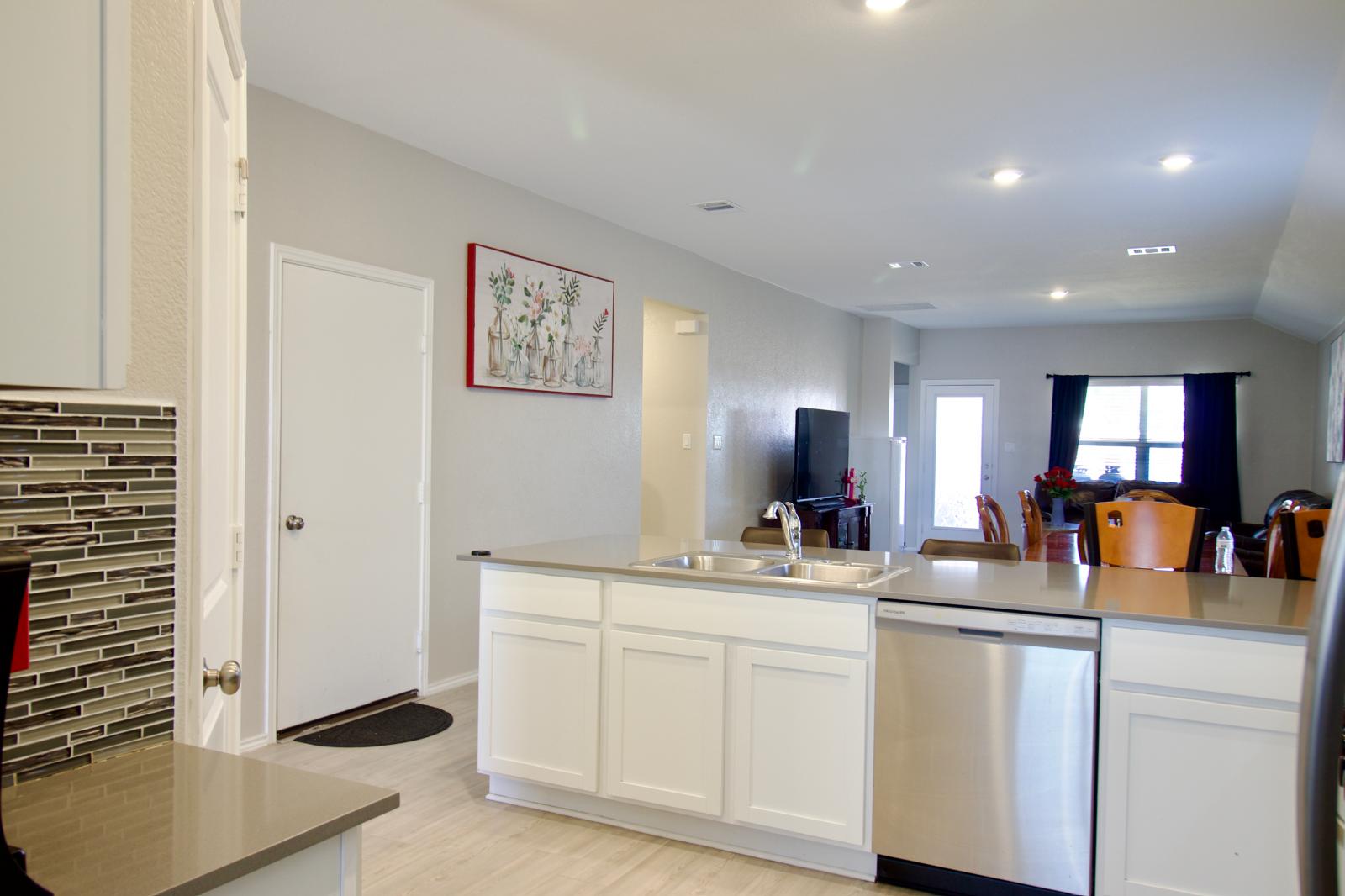 2545 Four Waters Loop Georgetown, TX 78628 - Photo 14 of 14 An open floorplan seamlessly connects the functional kitchen space directly to the adjacent living area.