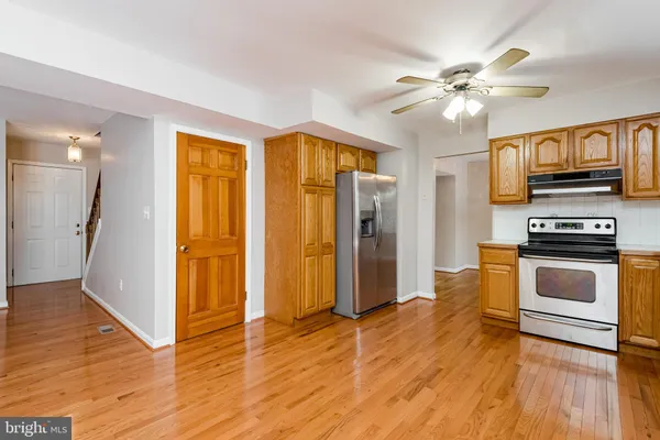 a view of kitchen with sink and refrigerator