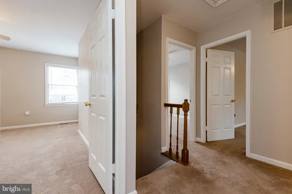 an entryway with a livingroom and a bathroom
