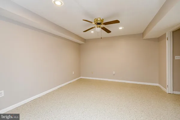 a view of an empty room with a ceiling fan