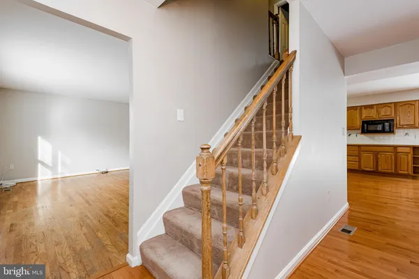 a view of entryway and hall with wooden floor