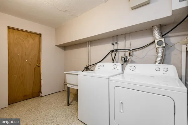 a view of a house with a large window and wooden fence