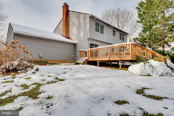 a view of a house with snow on the road