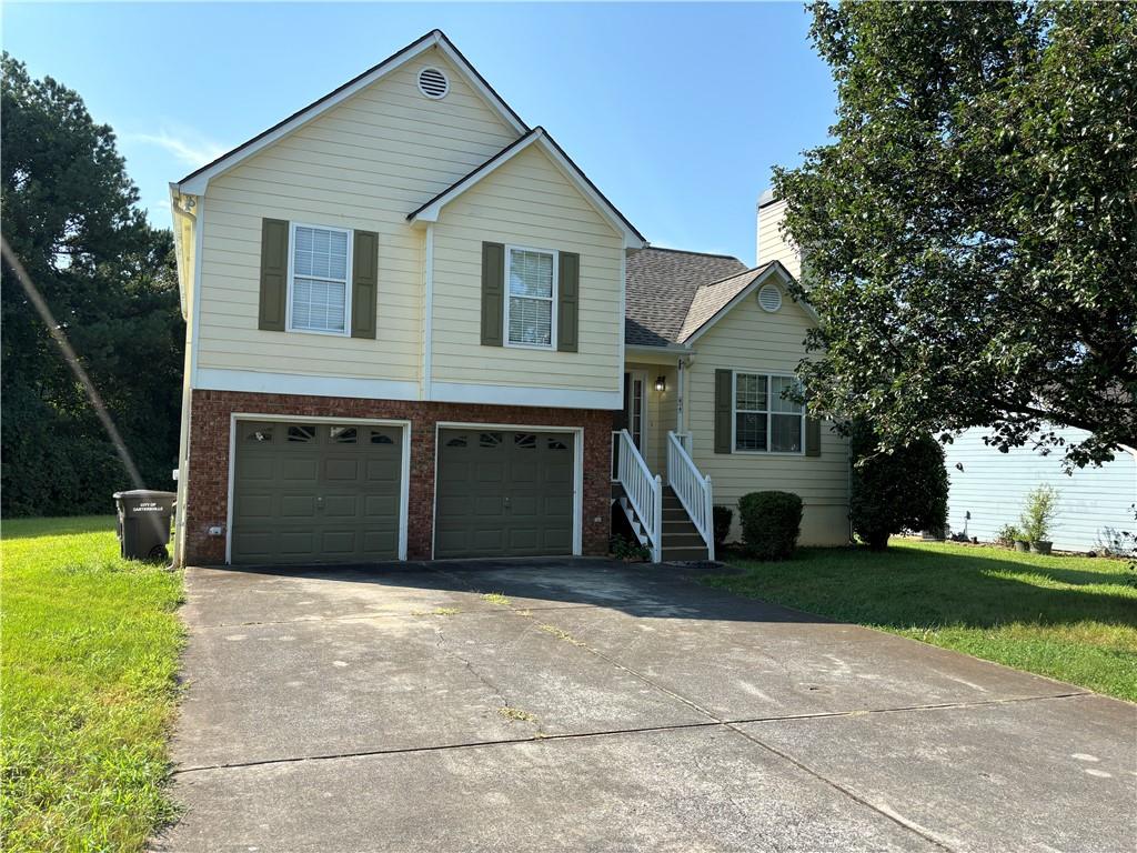 a front view of a house with yard and trees