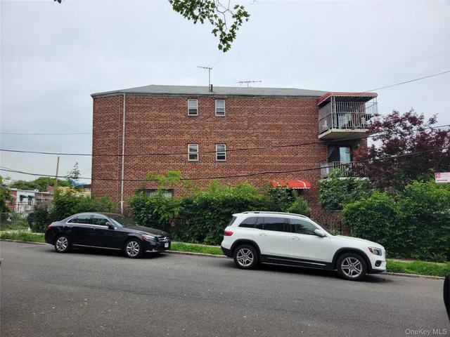 a car parked in front of a brick house