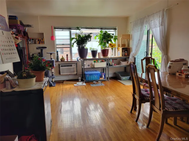a living room with furniture a floor to ceiling window and a flat screen tv