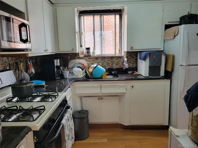 a kitchen with stainless steel appliances a stove a sink and a refrigerator