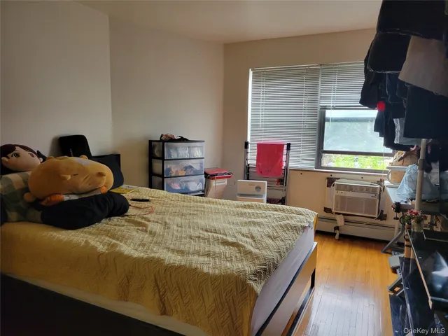 a bedroom with a bed and dresser