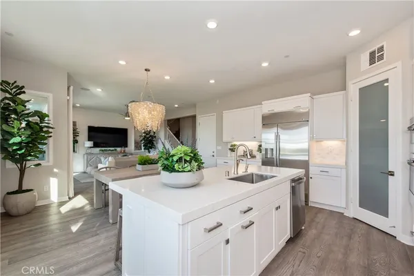 a kitchen with a white counter top space and living room
