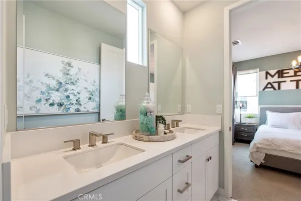 a bathroom with a double vanity sink and a bathtub