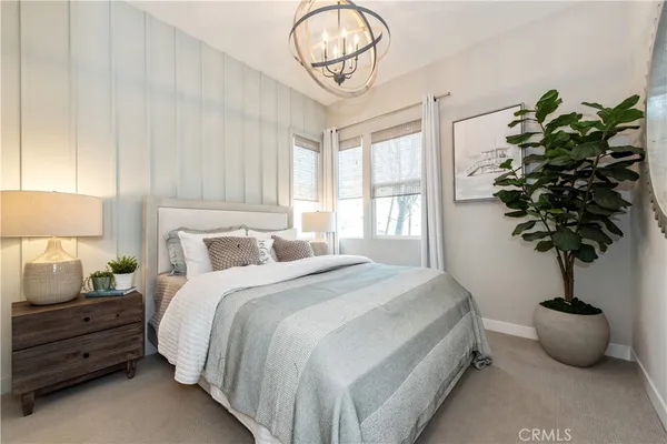 a bedroom with bed and a potted plant