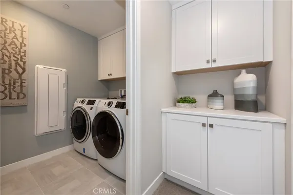 a utility room with sink dryer and washer