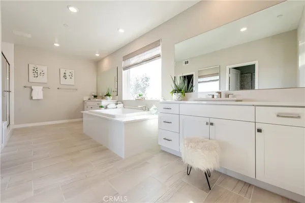 a view of a hallway with bathroom and mirror