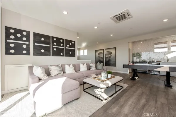 a living room with furniture and floor to ceiling windows