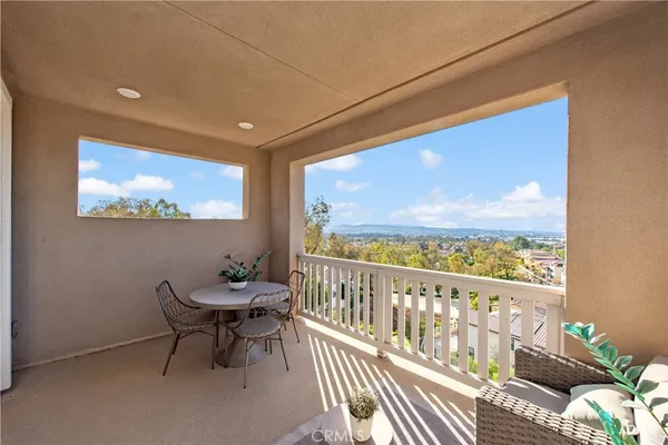 a view of a patio with table and chairs and potted plants