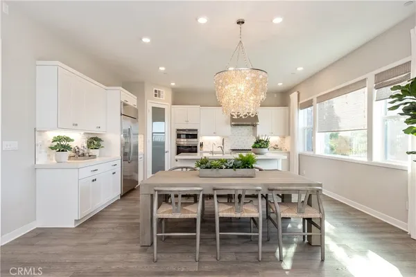 a kitchen with a table and chairs in it