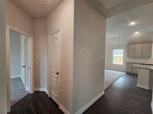 a view of a kitchen with wooden floor and electronic appliances