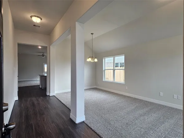 a view of a room with wooden floor and a window
