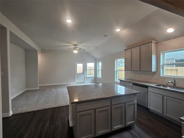 a kitchen with counter top space sink and center island