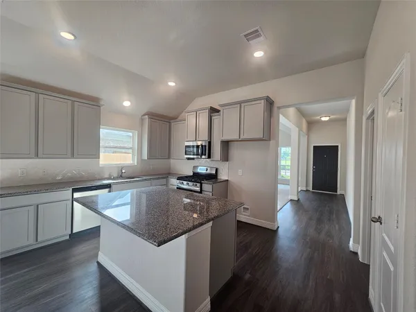 a kitchen with a sink stove and refrigerator