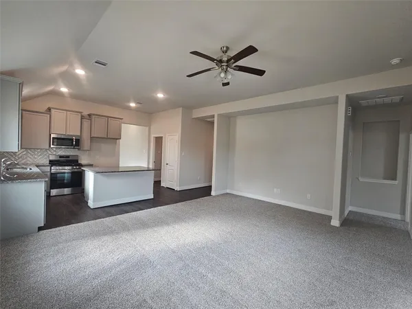 a view of a kitchen with a sink stainless steel appliances and cabinets