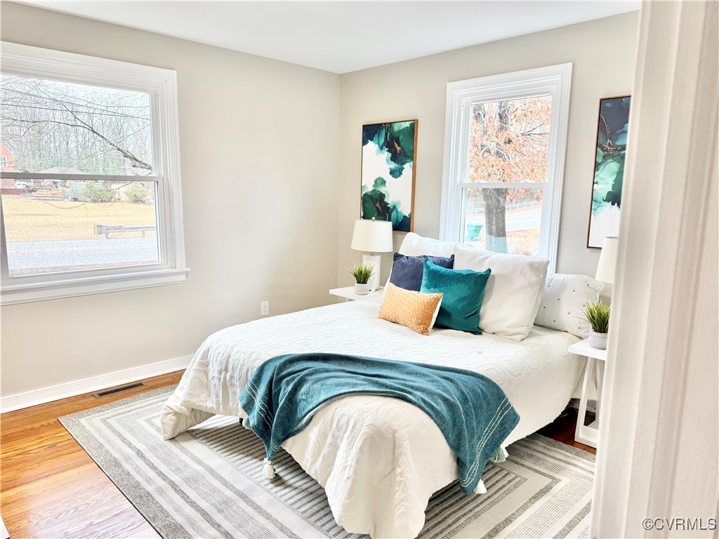 1809 Skipwith Road Henrico, VA 23229 - Photo 18 of 18 a bedroom with a bed and wooden floor