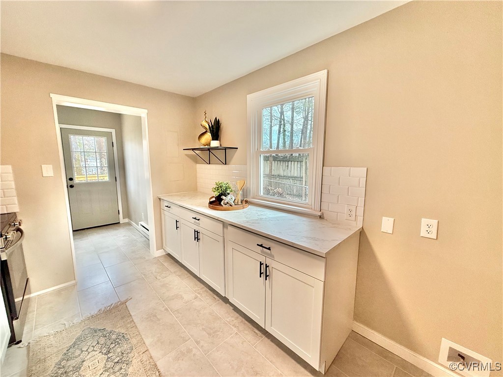 1809 Skipwith Road Henrico, VA 23229 - Photo 7 of 18 a kitchen with granite countertop white cabinets and white appliances