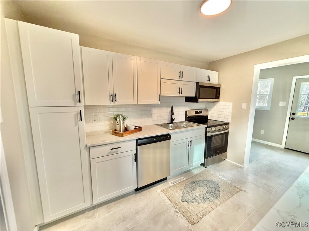 1809 Skipwith Road Henrico, VA 23229 - Photo 8 of 18 a kitchen with white cabinets and white appliances