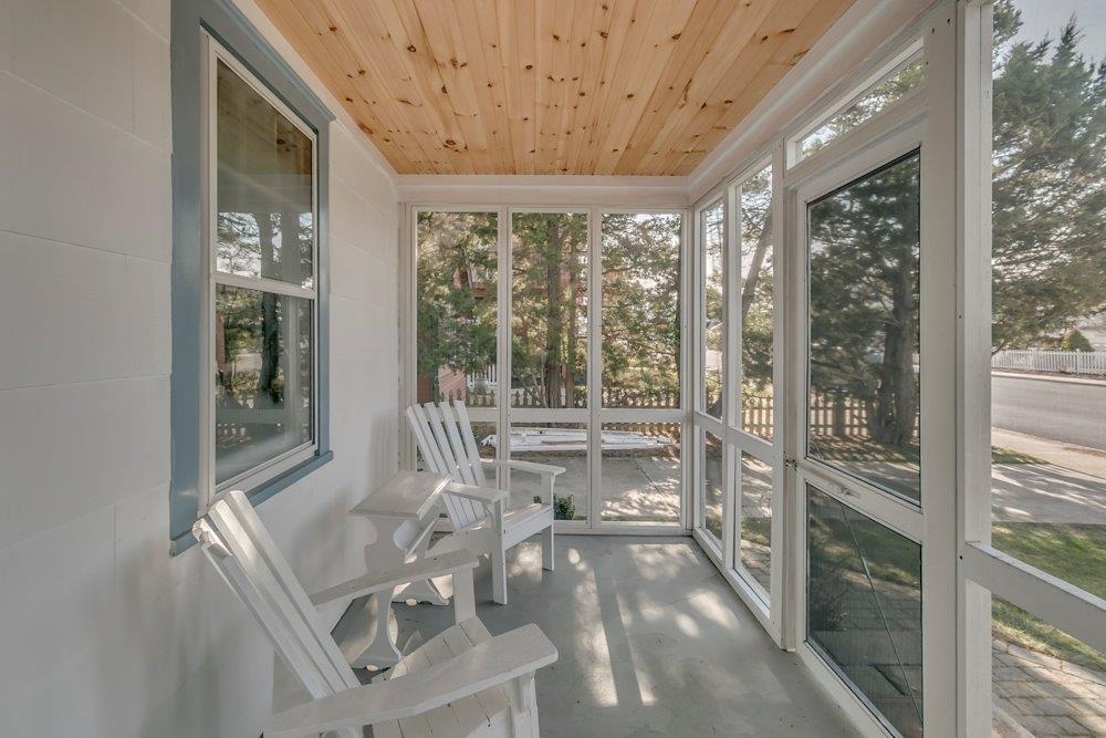 3149 1st Avalon, NJ 08202 - Photo 2 of 20 a room with a balcony a bed and a large window with balcony view