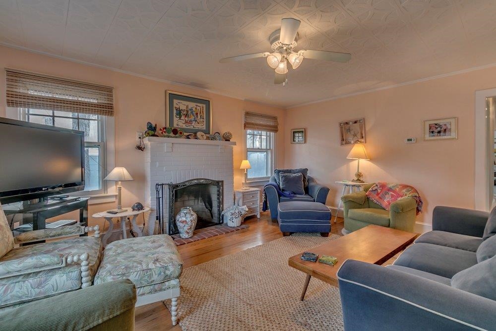 3149 1st Avalon, NJ 08202 - Photo 3 of 20 a living room with furniture a fireplace and a flat screen tv