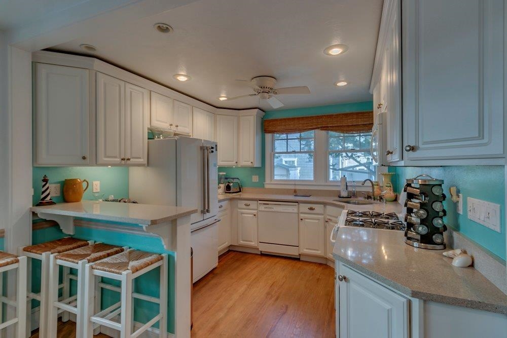 3149 1st Avalon, NJ 08202 - Photo 7 of 20 a kitchen with kitchen island granite countertop a stove a sink and a refrigerator