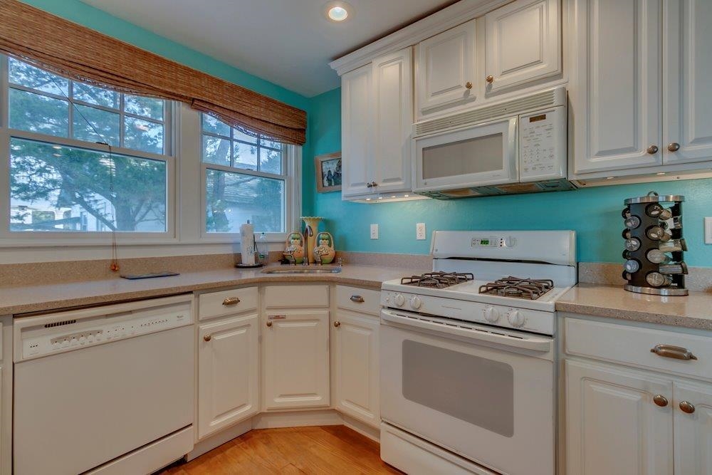 3149 1st Avalon, NJ 08202 - Photo 9 of 20 a kitchen with cabinets appliances a sink and a window