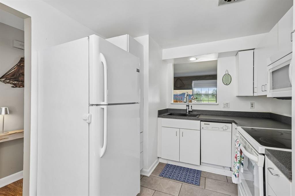 239 Whitestown Village, Unit F Butler, PA 16001 - Photo 11 of 40 a kitchen with a refrigerator and a sink