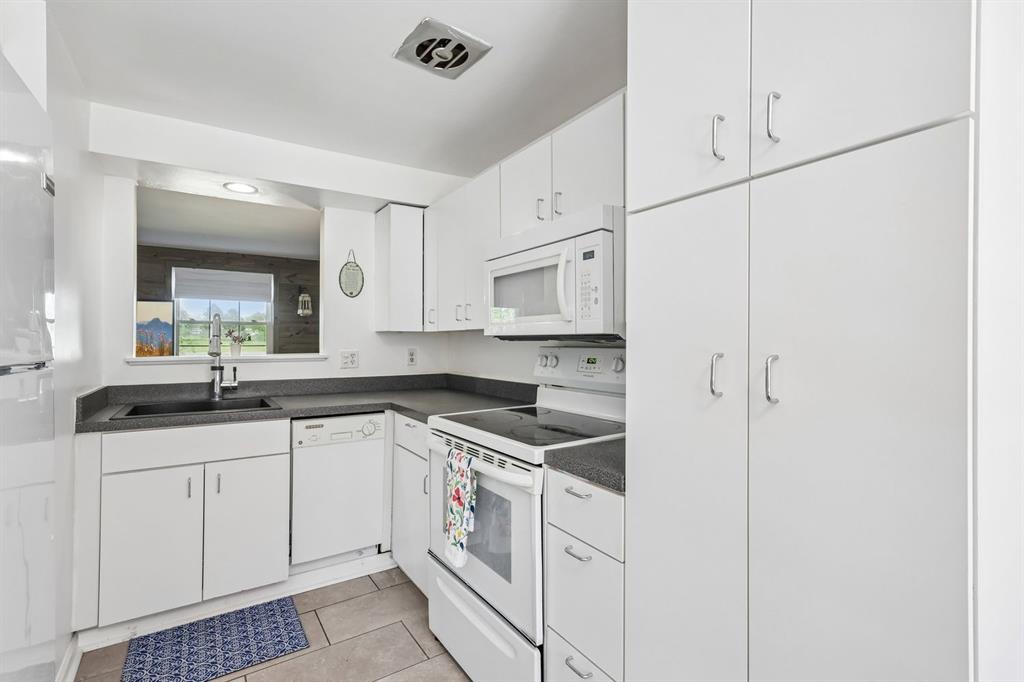 239 Whitestown Village, Unit F Butler, PA 16001 - Photo 12 of 40 a kitchen with granite countertop white cabinets and white appliances