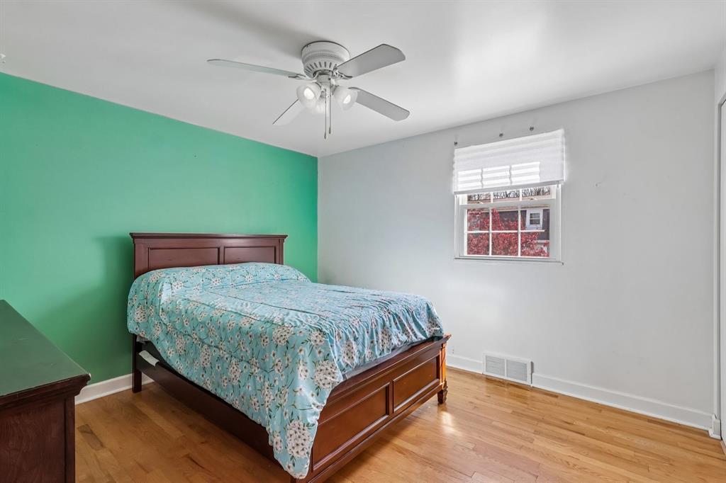 239 Whitestown Village, Unit F Butler, PA 16001 - Photo 19 of 40 a bedroom with a bed and a chandelier