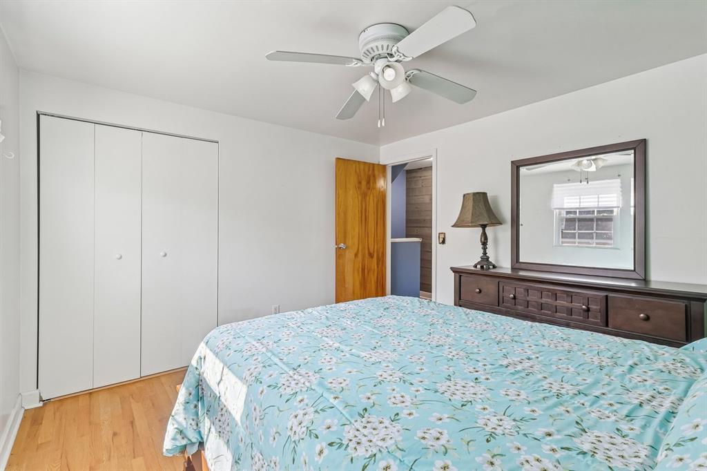 239 Whitestown Village, Unit F Butler, PA 16001 - Photo 21 of 40 a bedroom with a large bed and a chandelier