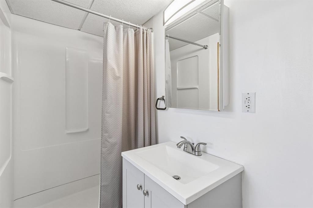 239 Whitestown Village, Unit F Butler, PA 16001 - Photo 29 of 40 a bathroom with a sink a mirror and shower curtain